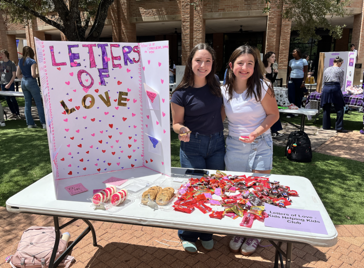 Sophomores Sienna DeSimone and Dalia Karni pose at their booth at the annual Club Fair during Belonging Week. Belonging Week is a yearly event that shows students different aspects of the Kinkaid Student Life and allows students to find groups who they align with. “I liked being able to hand out candy to everyone and I loved seeing all of my friend's booths and helping them set their booths up as well,” said sophomore Sienna DeSimone.